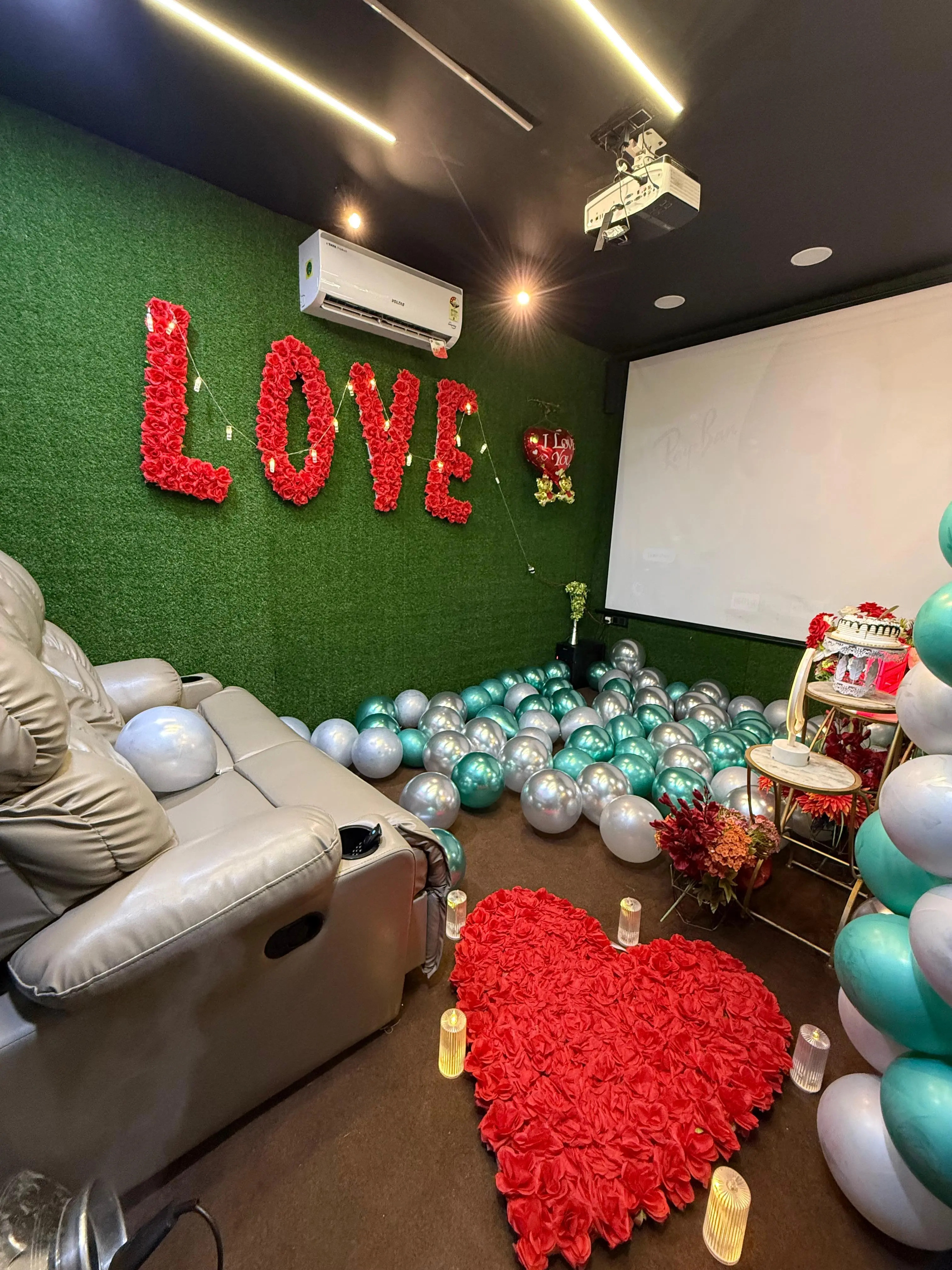 Rose petal heart and candlelit path inside a Spotlight private theater