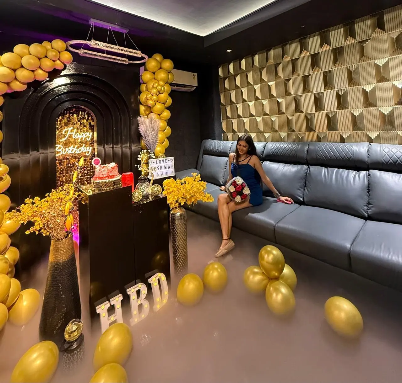 Guest posing for a photoshoot inside a decorated Spotlight celebration room
